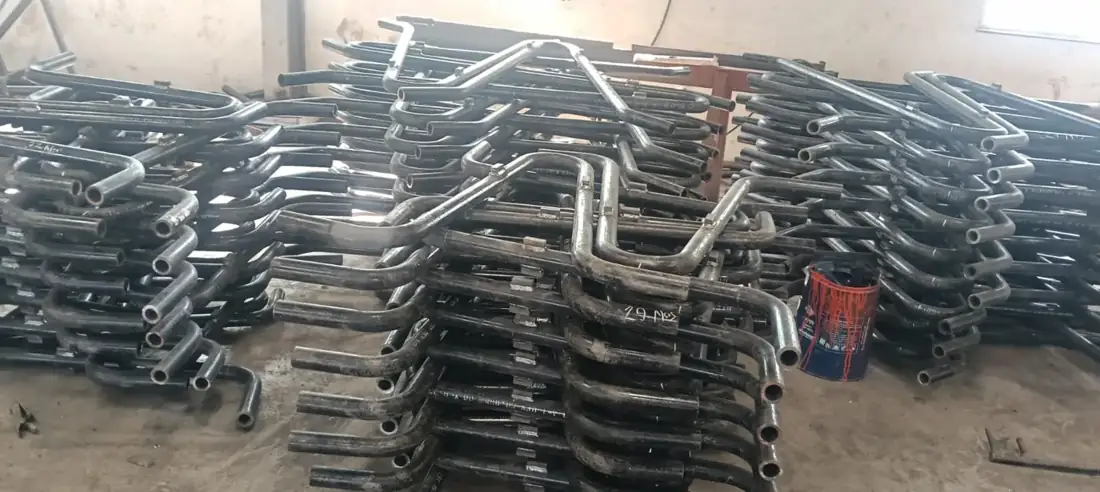 Cold-formed pipe bends stacked after forming